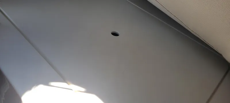 Slide: The Image of Interior view of a 2015 Century 30 boat, featuring a smooth, gray surface with a small hole. - 47