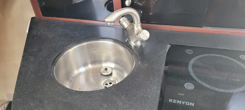 Slide: The Image of Compact kitchen sink and Kenyon cooktop in a 2015 Century 30 model. - 49