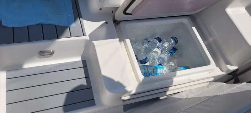 Slide: The Image of Cooler with bottled water and ice on a 2015 Century 30 boat deck. - 14