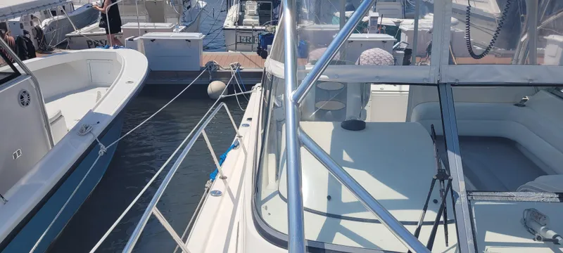 Slide: The Image of Two boats docked side by side, featuring a 2015 Century 30 model. - 34