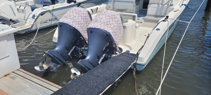 Slide: The Image of Century 30 boat, 2015 model, docked with dual outboard motors, covered in protective fabric. - 5