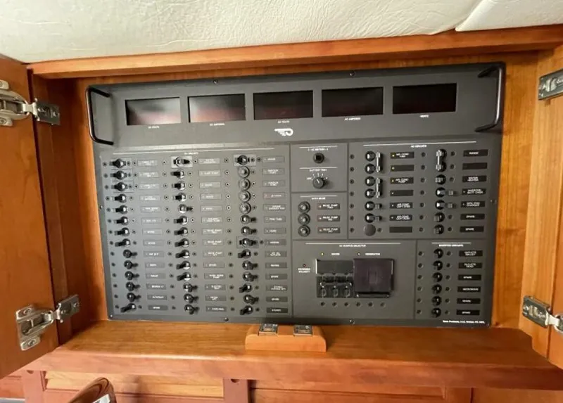 Slide: The Image of Control panel inside a 2012 Hinckley Talaria boat, featuring various switches and indicators. - 11