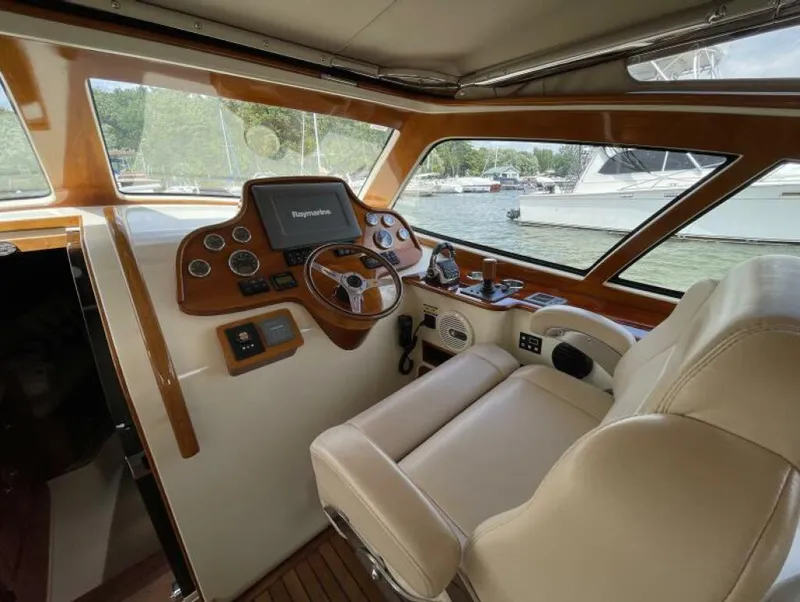 Slide: The Image of Helm of 2012 Hinckley Talaria boat with leather seating and navigation controls. - 4