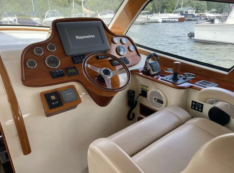Slide: The Image of Helm of 2012 Hinckley Talaria boat with Raymarine navigation system and luxurious seating. - 5