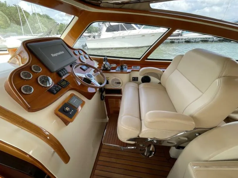 Slide: The Image of Luxurious 2012 Hinckley Talaria yacht helm with leather seating and advanced navigation controls. - 6