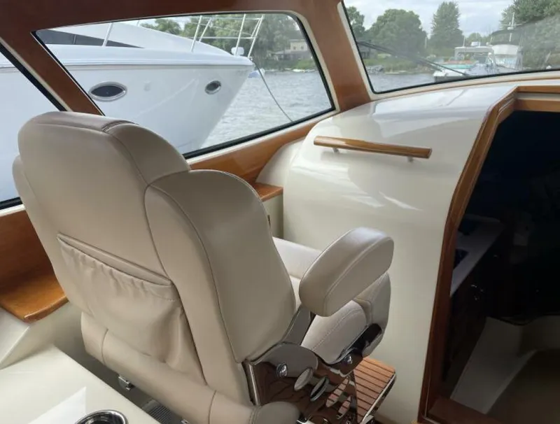 Slide: The Image of Interior of a 2012 Hinckley Talaria yacht with beige leather seating. - 8