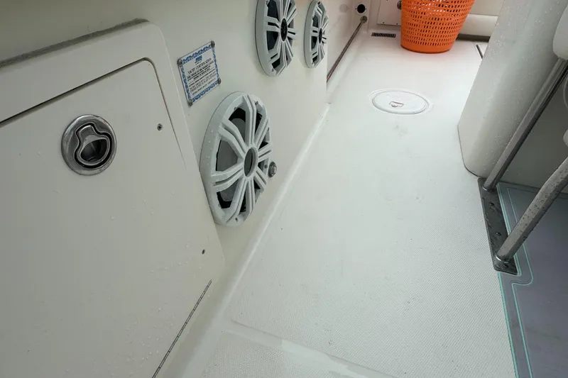 Slide: The Image of 2006 Hydra-Sports Vector 2900 CC boat interior with speakers and storage compartment. - 13