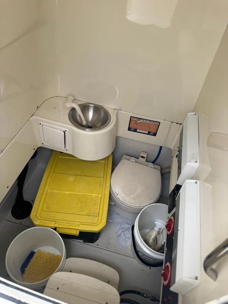 Slide: The Image of Interior of 2006 Hydra-Sports Vector 2900 CC boat with sink, toilet, and storage. - 6