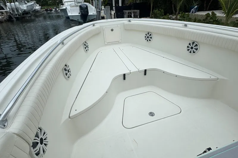 Slide: The Image of 2006 Hydra-Sports Vector 2900 CC boat interior with seating and speakers, docked by the water. - 7