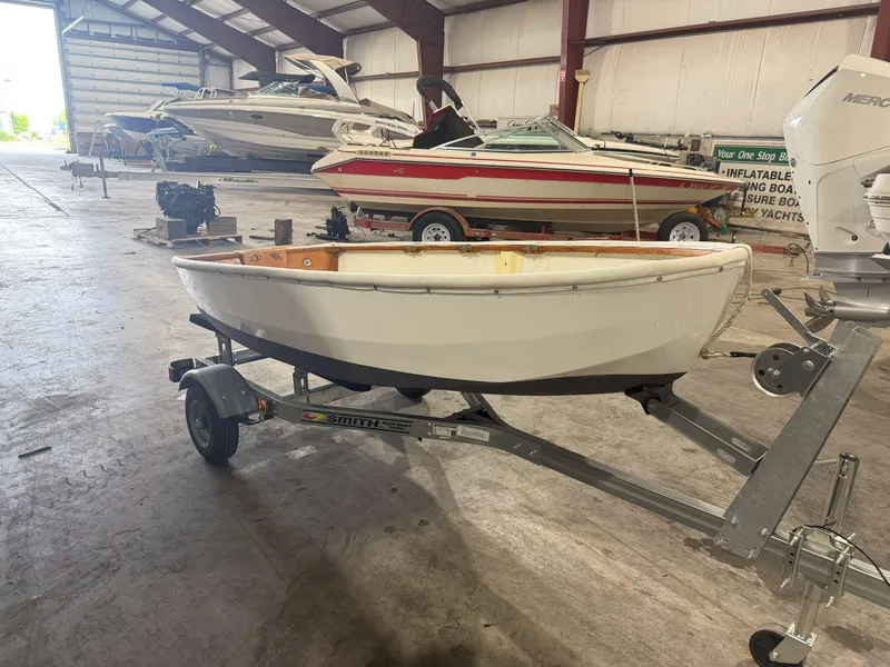 The Image of Small boat on trailer in warehouse, surrounded by larger boats, OKEAN Sumner 9, 1978 model. - 1