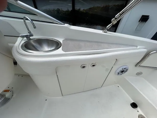 Slide: The Image of 2012 Sea Ray 260 Sundeck boat interior with sink and storage area. - 12