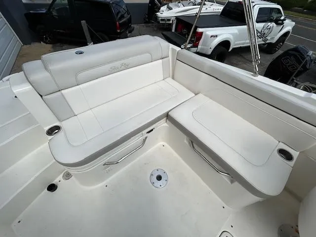 Slide: The Image of 2012 Sea Ray 260 Sundeck boat interior with white seating and cup holders. - 13
