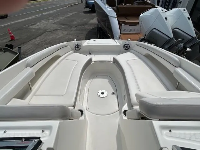 Slide: The Image of 2012 Sea Ray 260 Sundeck boat interior with white seating and speakers. - 15