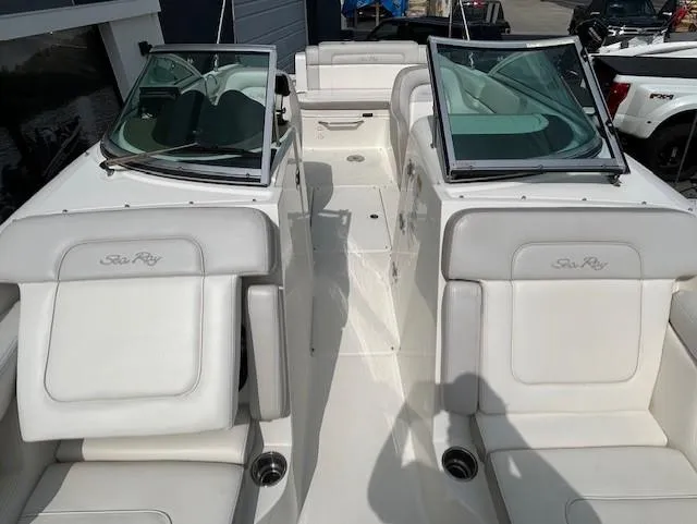 Slide: The Image of 2012 Sea Ray 260 Sundeck boat interior with white seating and dual windshields. - 17