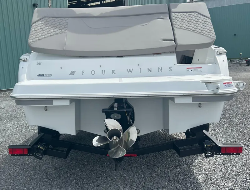 Slide: The Image of 2025 Four Winns H1 Freedom boat rear view with propeller and trailer. - 4