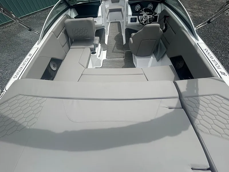 Slide: The Image of 2025 Four Winns H1 Freedom boat interior with gray seating and modern dashboard. - 6