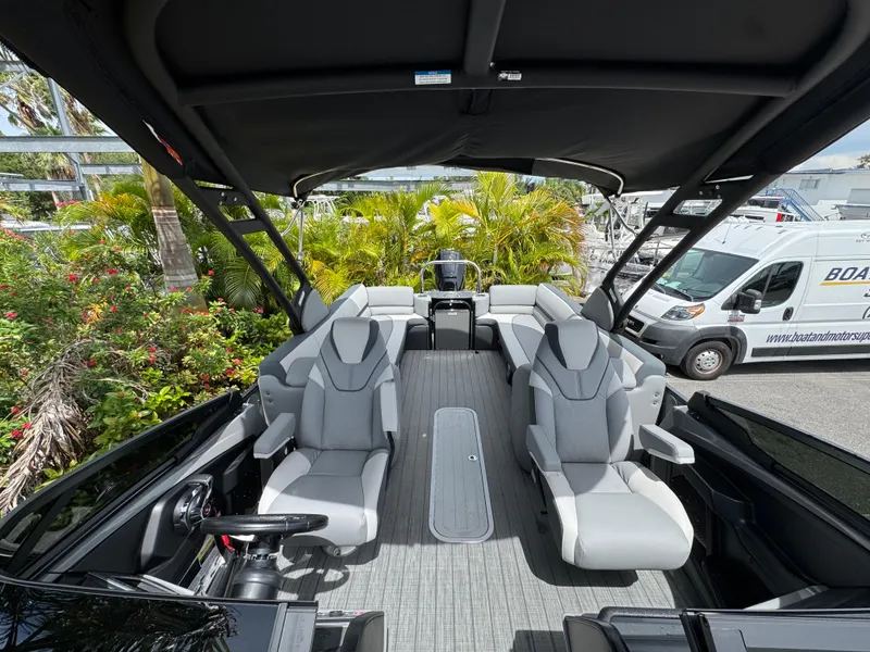 Slide: The Image of 2025 Avalon Catalina Platinum Quad Lounge boat interior with luxurious seating and canopy. - 18