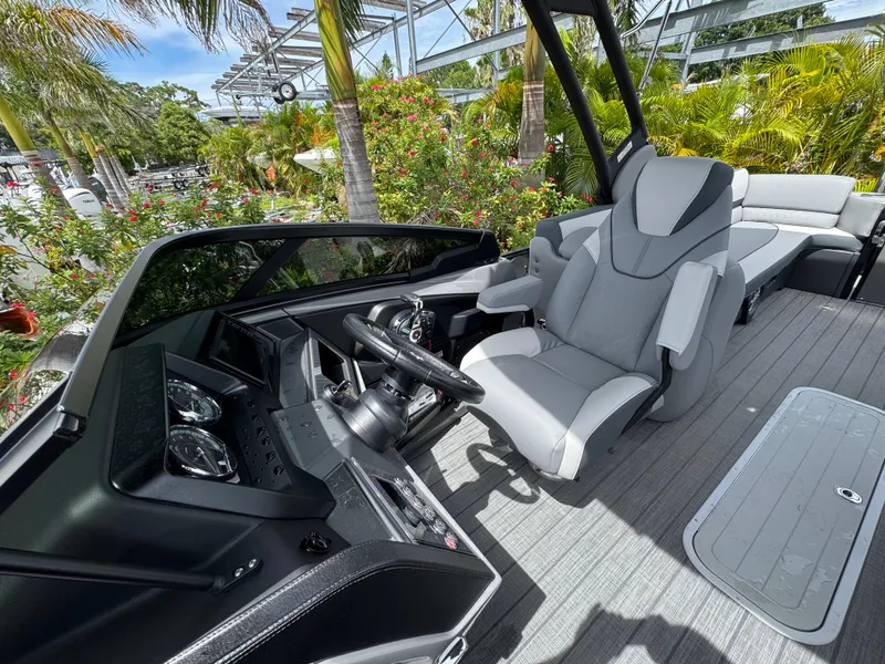 Slide: The Image of 2025 Avalon Catalina Platinum Quad Lounge boat interior with modern helm and seating. - 19