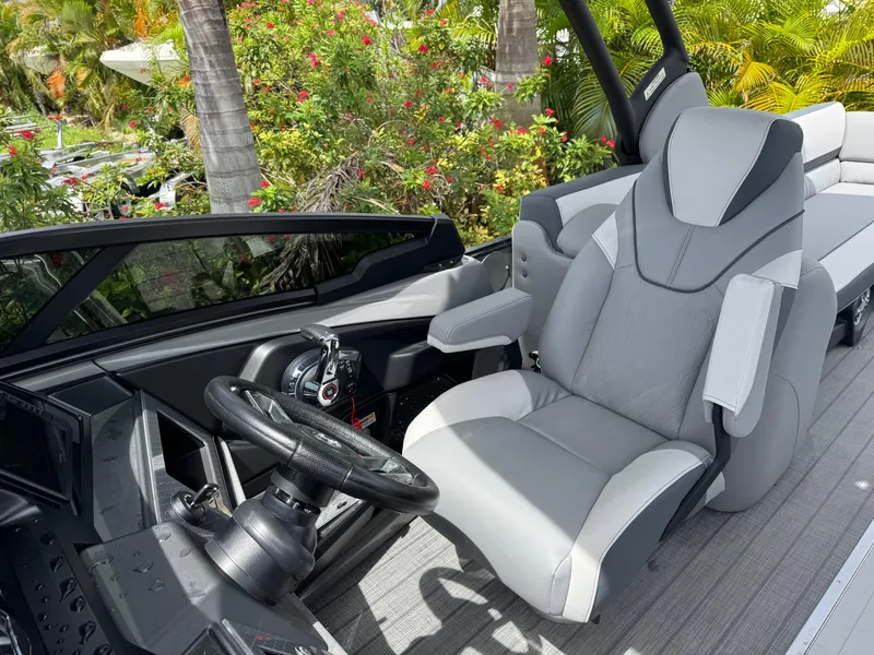 Slide: The Image of 2025 Avalon Catalina Platinum Quad Lounge interior with luxurious captain's chair and sleek dashboard. - 20