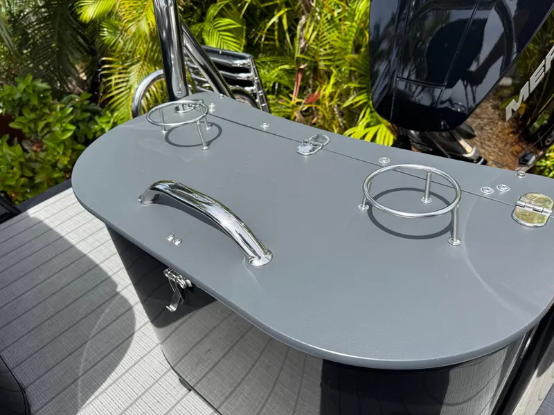 Slide: The Image of 2025 Avalon Catalina Platinum Quad Lounge boat with sleek gray surface and cup holders. - 30