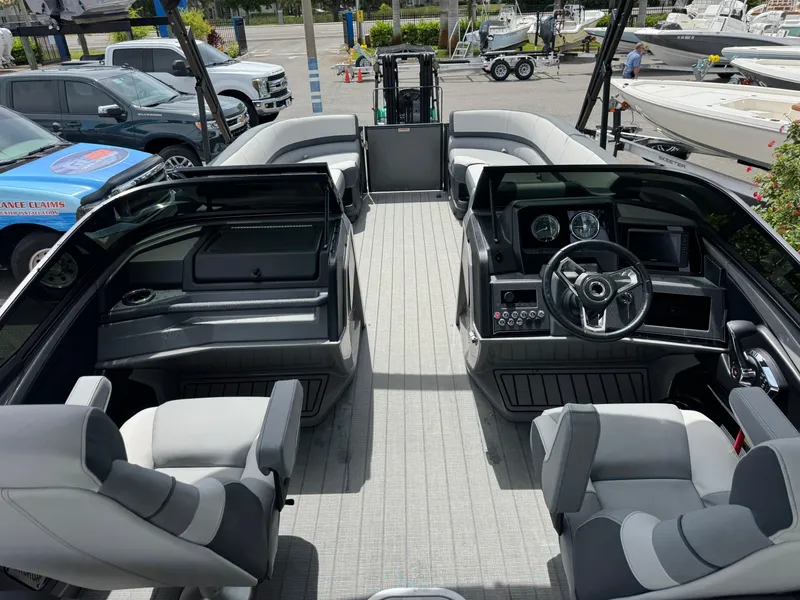 Slide: The Image of 2025 Avalon Catalina Platinum Quad Lounge boat interior with modern seating and control panel. - 35