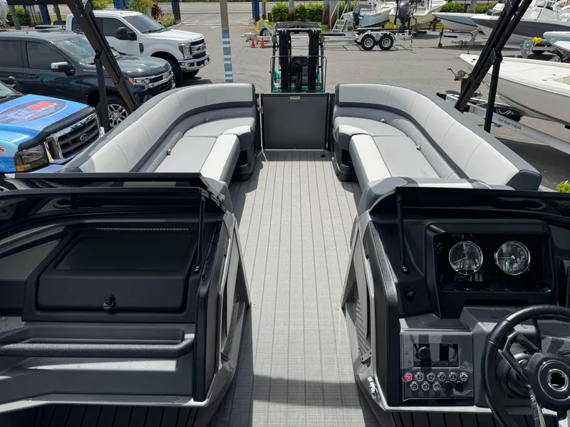 Slide: The Image of 2025 Avalon Catalina Platinum Quad Lounge boat interior with sleek seating and modern dashboard. - 36