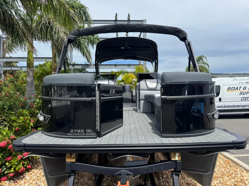 Slide: The Image of 2025 Avalon Catalina Platinum Quad Lounge boat, 27 feet, displayed outdoors with palm trees. - 4