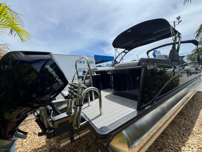 Slide: The Image of 2025 Avalon Catalina Platinum Quad Lounge boat with Mercury engine, sleek design, and modern features. - 8