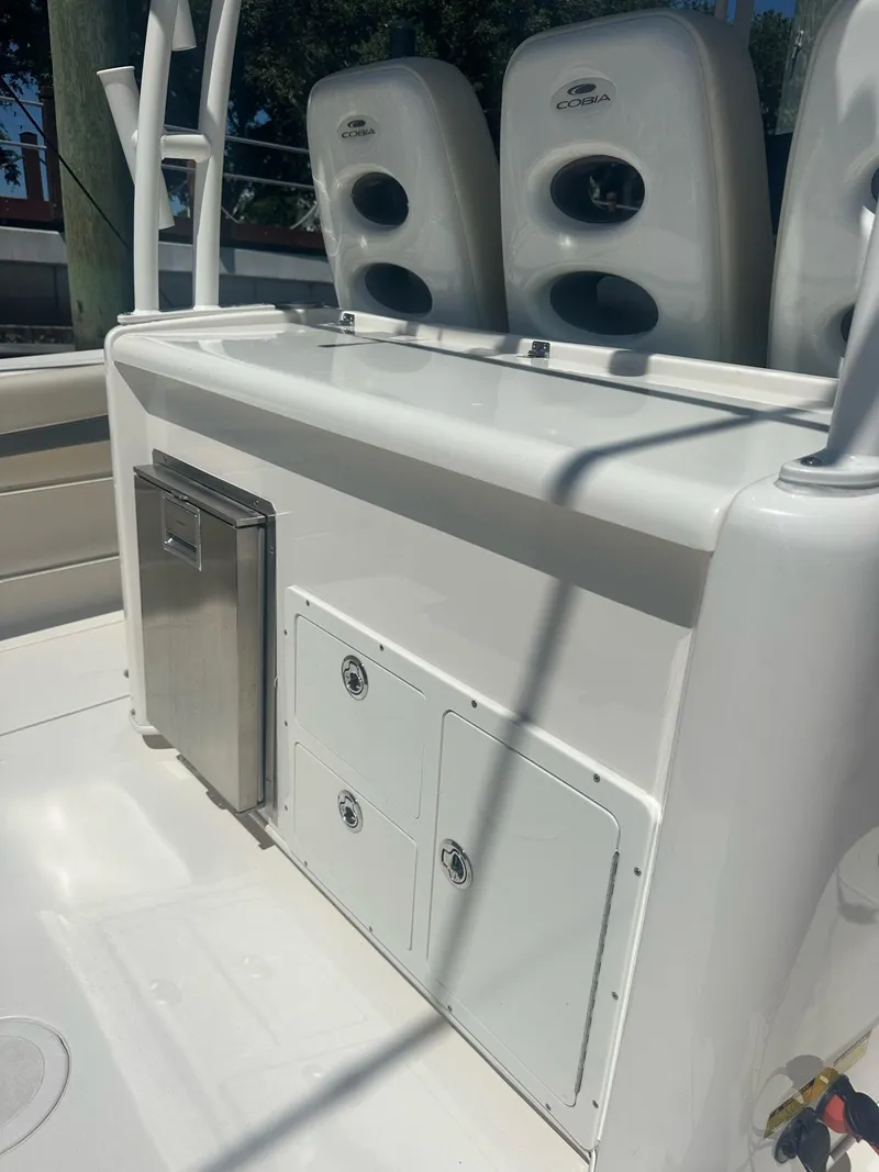 Slide: The Image of 2022 Cobia 350 Center Console boat interior with storage compartments and seating. - 11