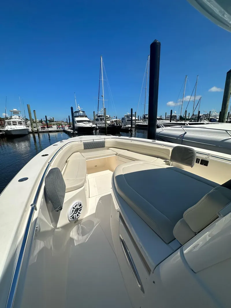Slide: The Image of 2022 Cobia 350 Center Console boat docked at marina under clear blue sky. - 9