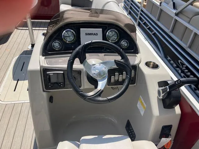 Slide: The Image of Steering console of 2021 G3 Suncatcher Fusion 322RC boat with Simrad display. - 3