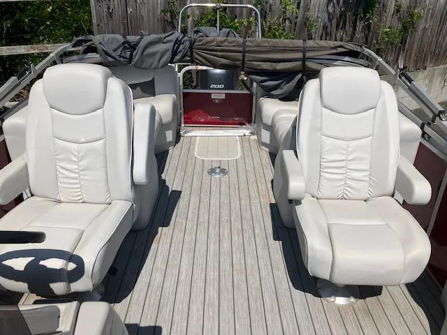 Slide: The Image of 2021 G3 Suncatcher Fusion 322RC boat with white leather seats and wooden deck. - 4