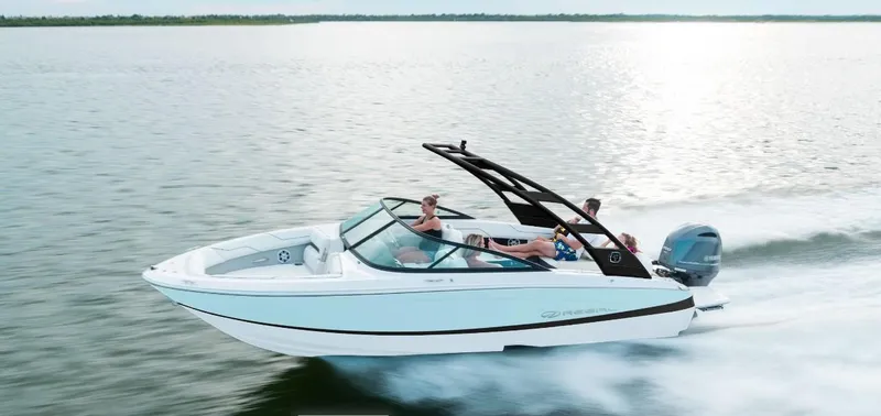 The Image of 2026 Regal LX2 boat cruising on a serene lake with passengers enjoying the ride. - 0