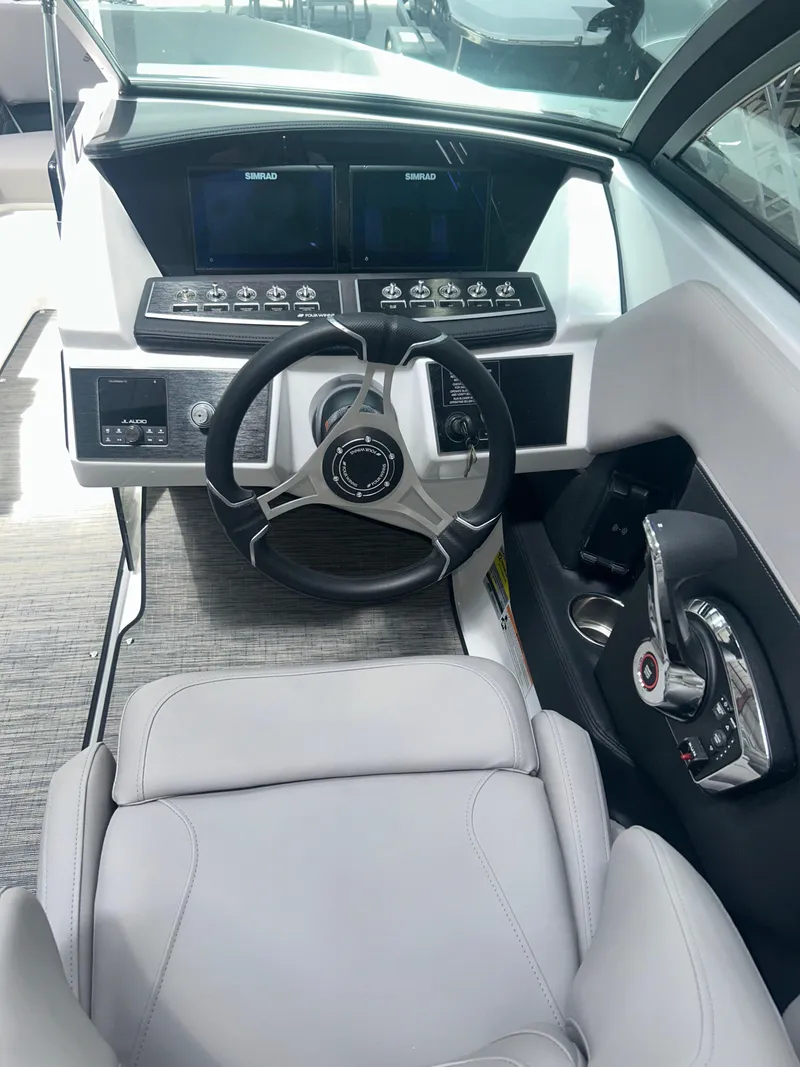 Slide: The Image of 2025 Four Winns H2 boat interior with cushioned seating and modern design. - 4