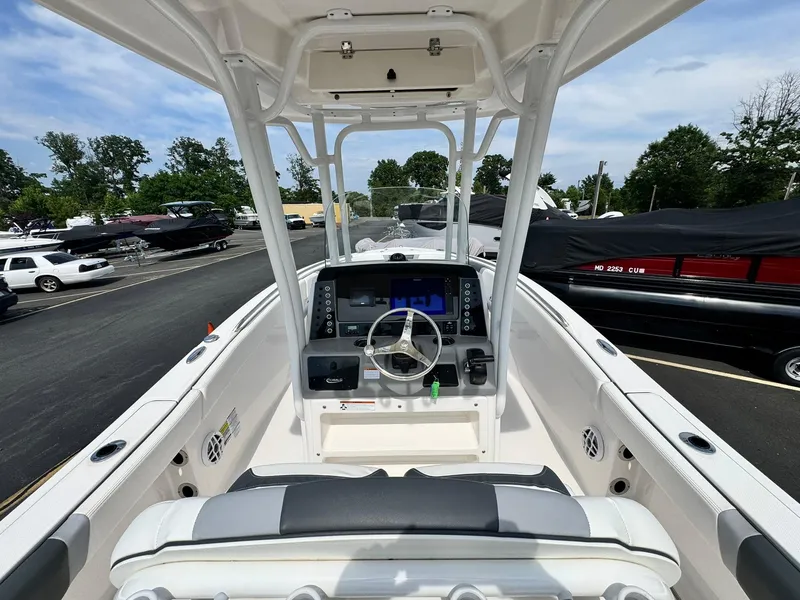 Slide: The Image of 2022 Robalo R230 Center Console boat interior with steering wheel and control panel. - 10