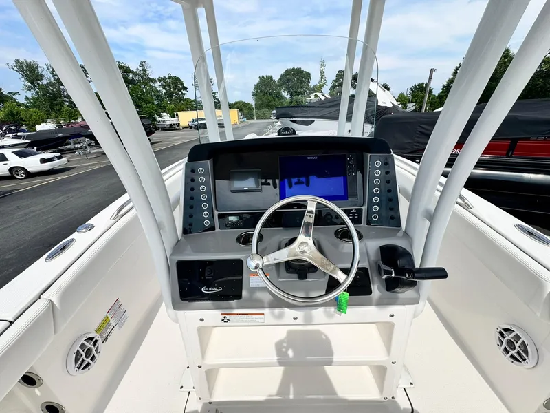 Slide: The Image of 2022 Robalo R230 Center Console boat dashboard with steering wheel and navigation display. - 11