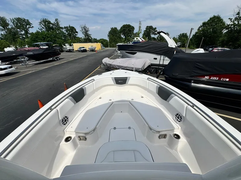 Slide: The Image of 2022 Robalo R230 Center Console boat in a marina, showcasing spacious seating and sleek design. - 12