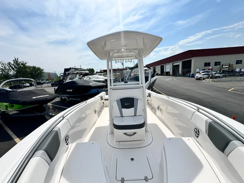 Slide: The Image of 2022 Robalo R230 Center Console boat at a marina under a clear sky. - 13