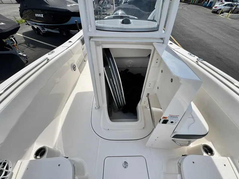Slide: The Image of 2022 Robalo R230 Center Console boat with open storage compartment. - 14