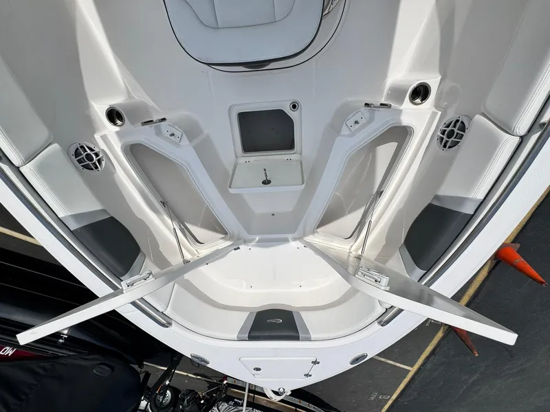 Slide: The Image of 2022 Robalo R230 Center Console boat interior with open storage compartments. - 16