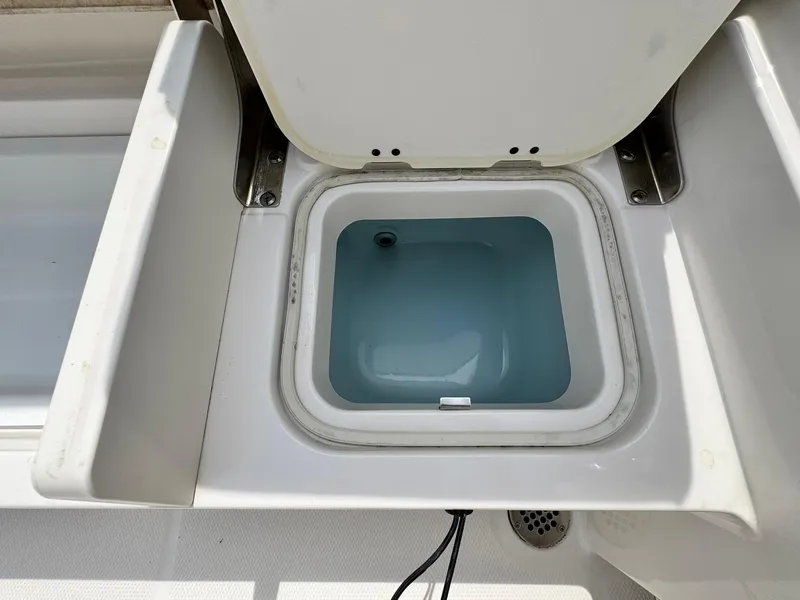 Slide: The Image of Open storage compartment on 2022 Robalo R230 Center Console boat. - 18