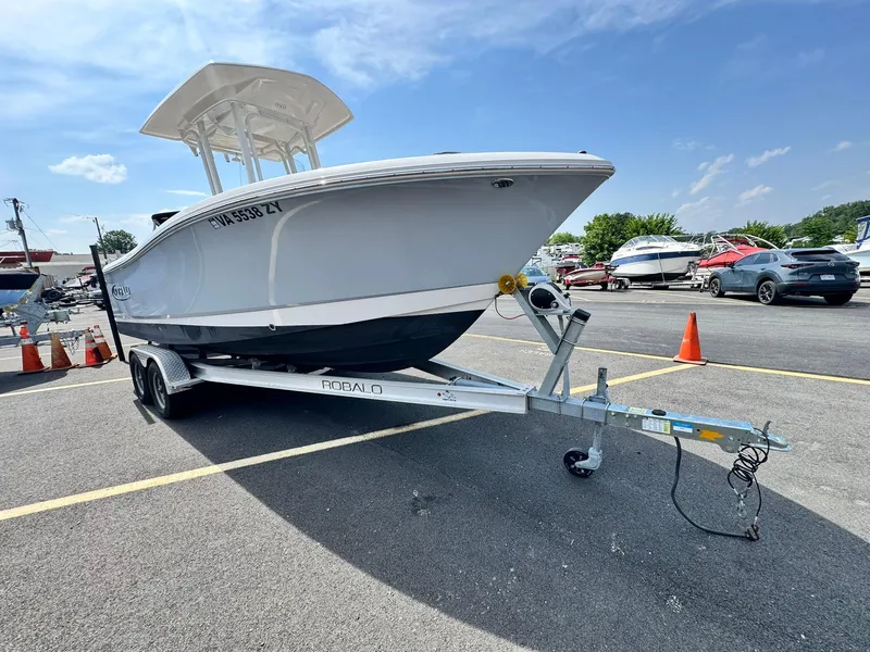 Slide: The Image of 2022 Robalo R230 Center Console boat on trailer in parking lot. - 2