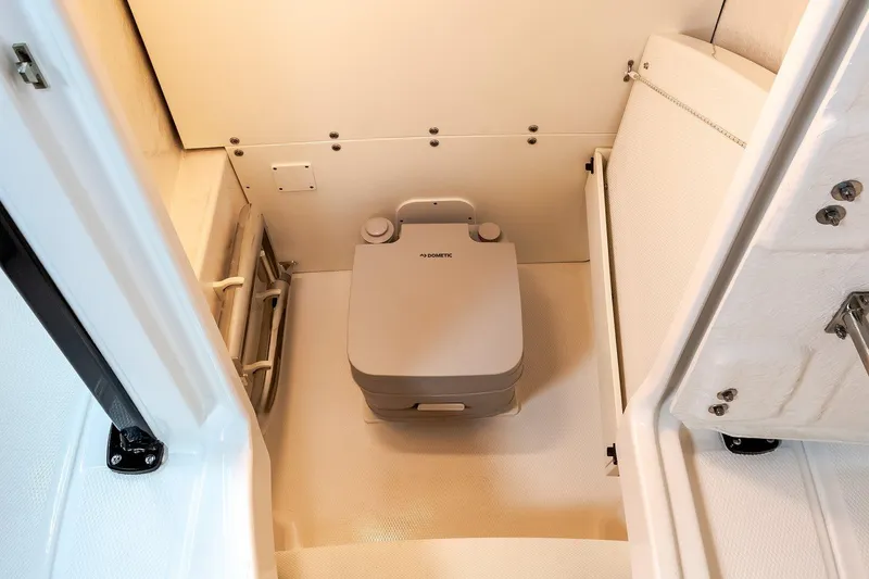 Slide: The Image of Manufacturer Provided Image: 2022 Robalo R230 Center Console boat interior with portable toilet. - 22