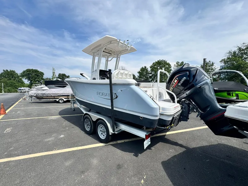 Slide: The Image of 2022 Robalo R230 Center Console boat on trailer in parking lot. - 5