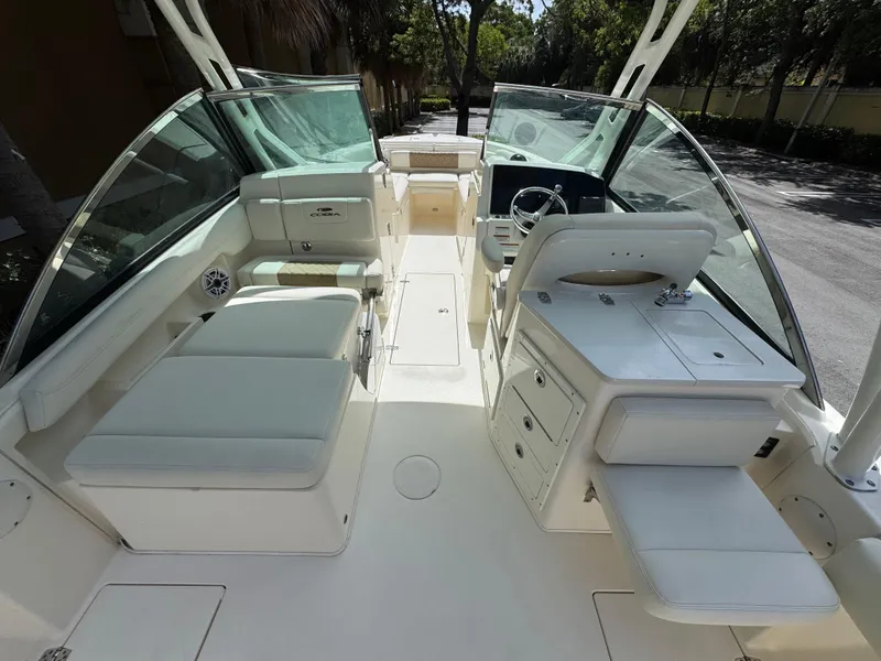 Slide: The Image of 2021 Cobia 240 Dual Console boat interior with seating, helm, and storage compartments. - 13