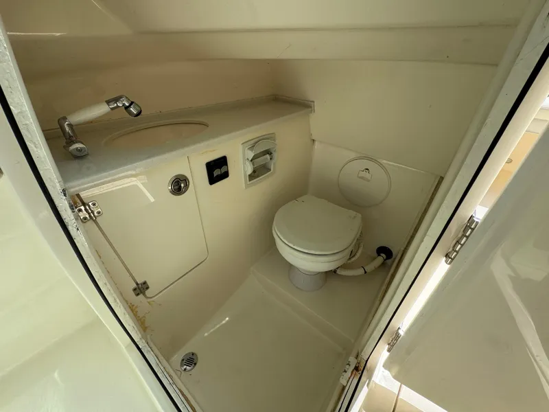 Slide: The Image of 2021 Cobia 240 Dual Console boat bathroom with sink and toilet. - 14