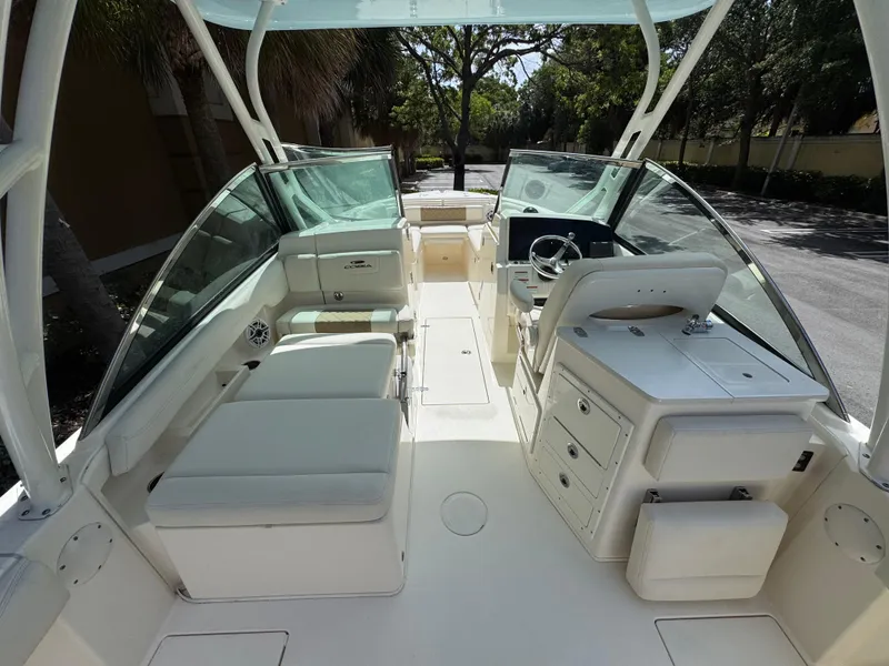 Slide: The Image of 2021 Cobia 240 Dual Console boat interior with seating and steering wheel. - 15