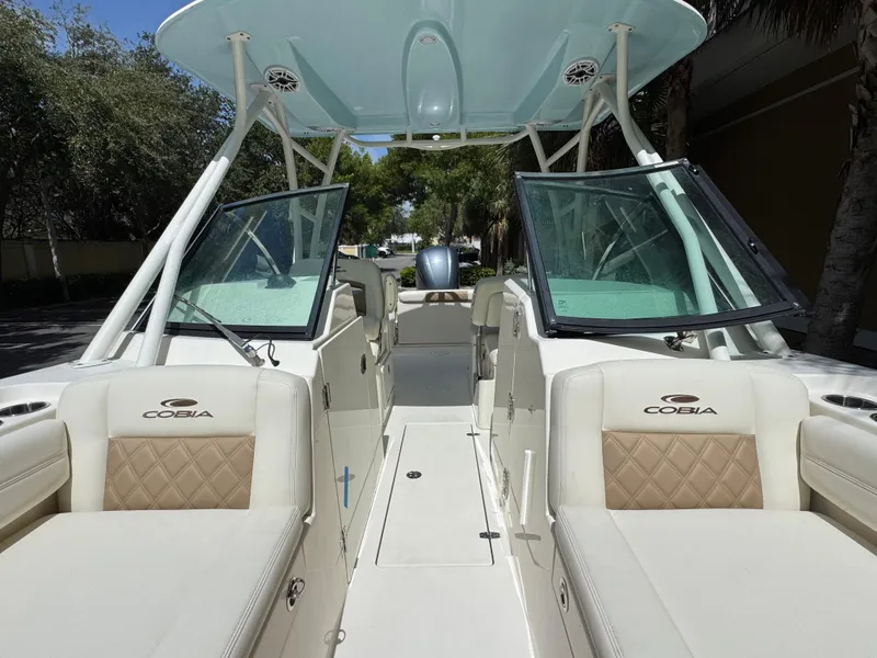 Slide: The Image of 2021 Cobia 240 Dual Console boat interior with open windshield and seating. - 17