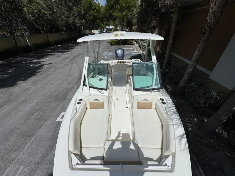 Slide: The Image of 2021 Cobia 240 Dual Console boat parked, featuring spacious seating and sleek design. - 18