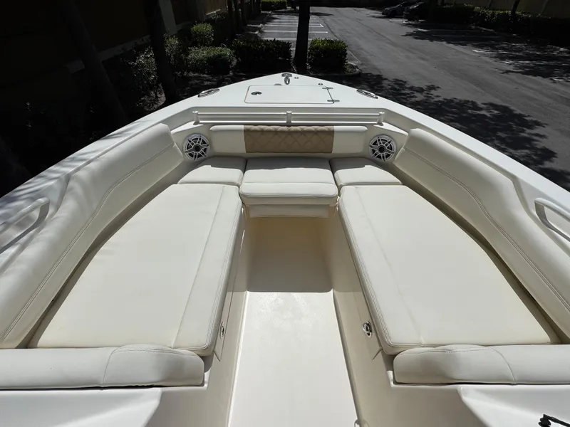 Slide: The Image of 2021 Cobia 240 Dual Console boat with spacious white seating area. - 19